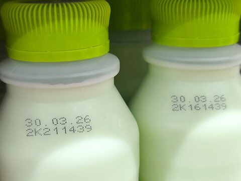 Select focus of the expiration date stamped on milk bottle. Expire date. Dairy product. For manufacturing, quality control, packaging design, consumer goods, and product labeling
