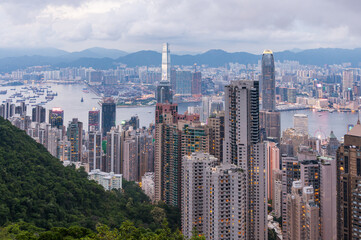 Fototapeta premium View of Hong Kong and Kowloon from Victoria peak. Evening, sunset. Panorama of Hong Kong, skyscrapers and nature. 21 May 2025, Hong Kong, China
