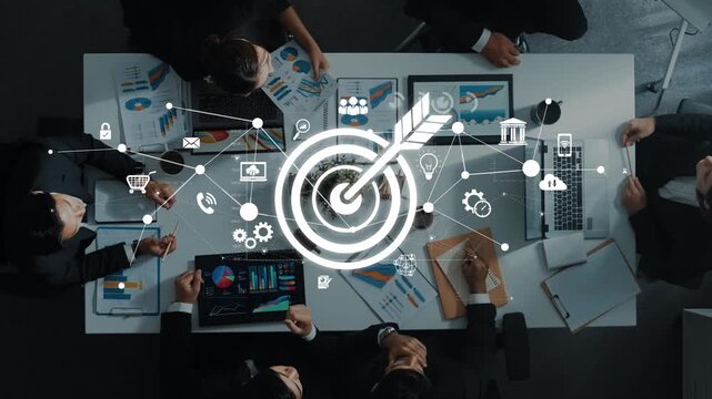 A top-down view of a business meeting where professionals collaborate on strategic goals, illustrated by digital icons representing innovation and marketing insights. Raster