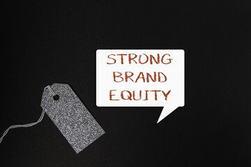 Strong brand equity concept displayed on a speech bubble with a glittery tag, emphasizing marketing strategies and business growth in a professional setting
