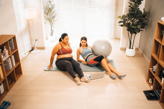 Fitness workout yoga pilates home living room woman female exercise ball mat in living room home as female woman do yoga pilates workout on mat with exercise ball at home