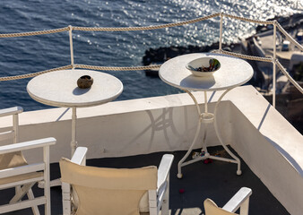 Fototapeta premium Terrace in Oia with amazing view of sunset over caldera in Santorini Island. Greece