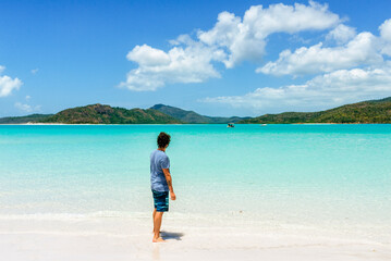 Man looking at turquoise water of Whitehaven Beach in Whitsunday Islands