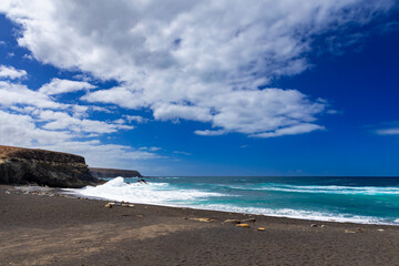 Rock formations and caves on the Atlantic Ocean coast in Ajuy, Fuerteventura, wallpaper or background for your project © anettastar