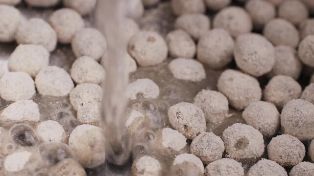 Organic tapioca pearls close-up in a bowl on a wooden table, asian dessert dish, chinese traditional drink, dry pearl.