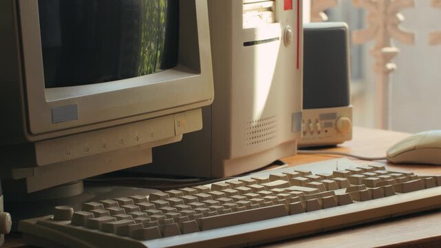 Man working and gaming on retro computer PC, IT engineer with vintage computer at home, using old fashion technology, close up of retro setup. 