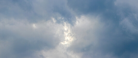 Obraz premium Dark storm clouds with glimpse of sunlight dramatic sky before rain atmospheric background natural light