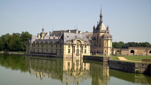 French Renaissance castle reflected in lake, Chantilly, northern France
