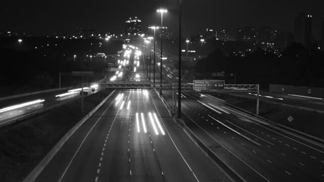 Highway 401 in Toronto from Don Mills overpass. Night time lapse. Black & white. HD video. 