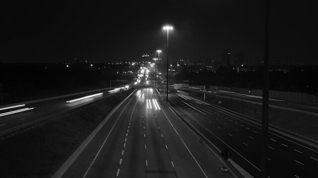 Highway 401 in Toronto from Don Mills overpass. Wide. Night time lapse. Black & white. HD video. 