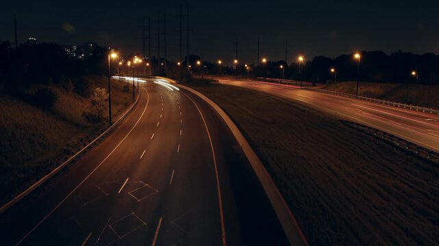 Don Valley Parkway time lapse at night, Toronto. Corner with streaking lights. HD Video.