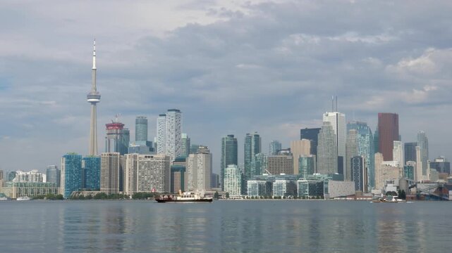 Toronto skyline on summer morning with boat. Toronto, Ontario, Canada. 4K stock video.