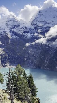 Scenic Lake Oeschinen in Switzerland with turquoise alpine water, dramatic mountain peaks and peaceful natural landscape in the Bernese Oberland, perfect for travel, hiking and tourism concepts