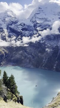 Scenic Lake Oeschinen in Switzerland with turquoise alpine water, dramatic mountain peaks and peaceful natural landscape in the Bernese Oberland, perfect for travel, hiking and tourism concepts