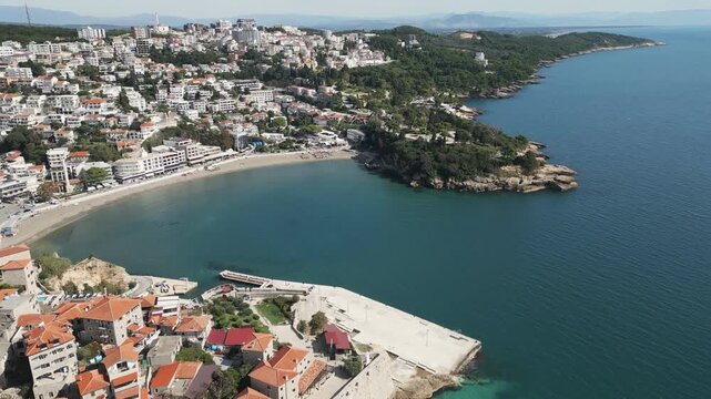 Drone flying towards a small sandy beach in Ulcinj, Montenegro.