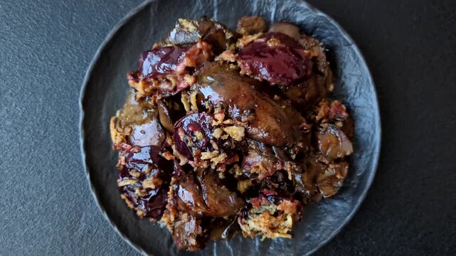 Chicken, duck, or goose liver with plums, onions, and spices. Chicken liver as a food background for your design