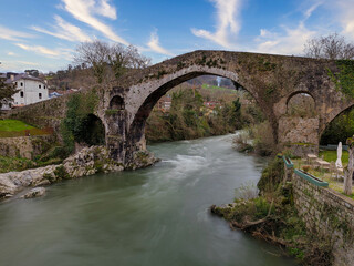Fototapeta premium Old Roman stone bridge in Cangas de Onis over Sella river, Asturias, Spain