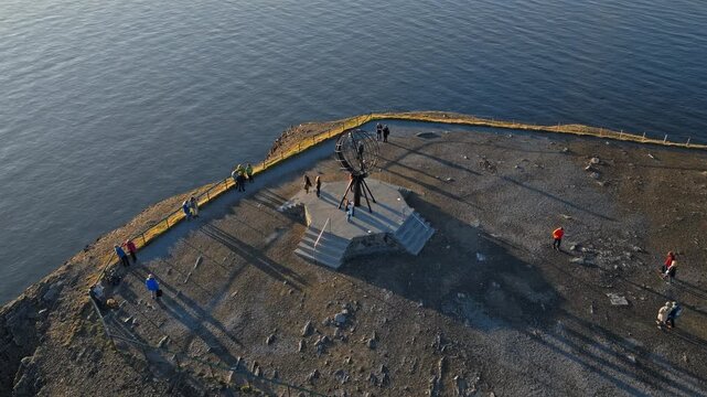 Drone aerial above the North Cape viewing platform on the edge of the Arctic cliffs in Norway. Visitors gather at the famous northern viewpoint.