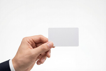 Fototapeta premium Man in a suit holding a blank white gift card or business card
