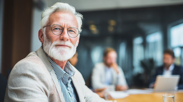 Senior business professional looking at camera during meeting, showing experience and leadership