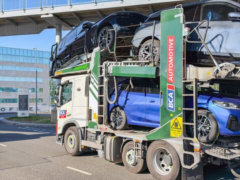 London, England, UK - 20 May 2025: Fully loaded car transporter driving on a road in London. The vehicle is operated by BCA Automotive, British Car Auctions.