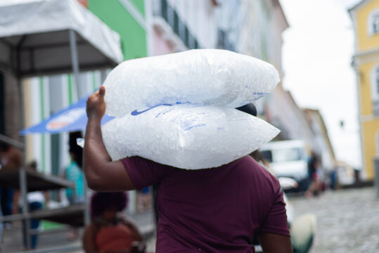 Worker carrying bags of ice