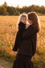 Fototapeta premium Caucasian Mother And Daughter In Close Hold In Golden Field, Mother Offering Comfort And Solace, Soft Facial Expression, Detailed Portrait Angle, Warm Backlight, Maternal Protection Theme