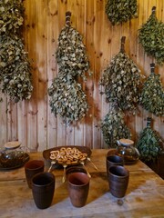 Traditional Eastern European banya interior with birch whisks, herbal tea and rustic wooden sauna...