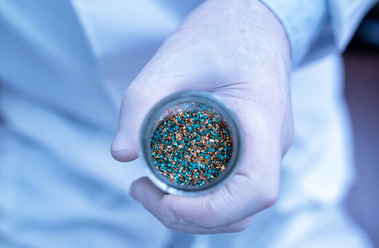 Chemist holding essential critical minerals for modern innovation and future technology