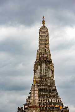 Central Prang Tower of Wat Arun Temple Against Cloudy Sky in Bangkok Thailand