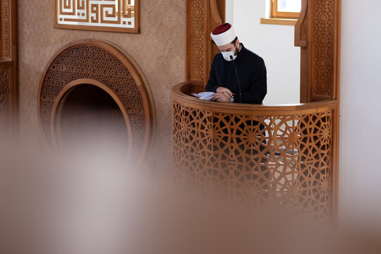 Imam Giving Khutbah from Minbar Inside Mosque Wearing Face Mask