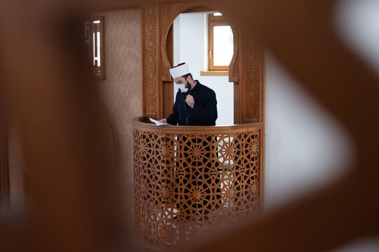 Imam Giving Khutbah from Minbar Inside Mosque Wearing Face Mask