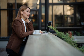 Businesswoman contemplating while working remotely outdoors