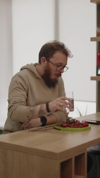 Bearded Man Enjoying a Healthy Meal at Home in His Modern Kitchen