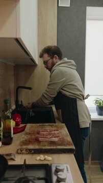 Man Washing Hands in a Modern Kitchen Before Preparing a Delicious Meal