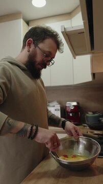 Man Preparing Eggs in a Modern Kitchen for a Healthy Homemade Meal