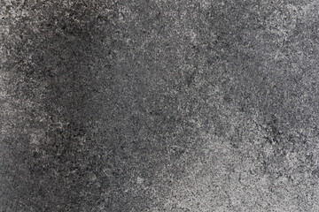 Fototapeta premium Close-up view of a textured surface with shades of gray showing rough and smooth patterns in natural light