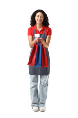 Female African-American cashier with shopping bags on white background