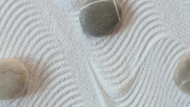 Zen garden with a white sand and the stones