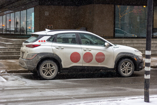 MONTREAL, CANADA, 23 December 2025 : Security vehicle parked in snowy urban setting, branded car on winter street, cityscape in cold weather