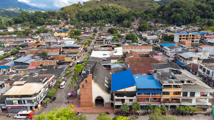 Fototapeta premium Cimitarra, Santander - Colombia. February 25, 2026. Panoramic drone view of the town's main church.