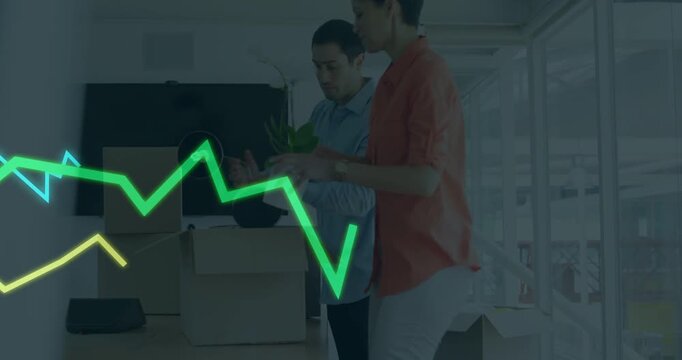 Vertical video: Boxes arriving, pair unpacking for business placing plant while neon chart syncing