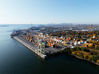 Naklejka premium Aerial view of port industrial tanks and container yard near river in Montreal, Canada. g.