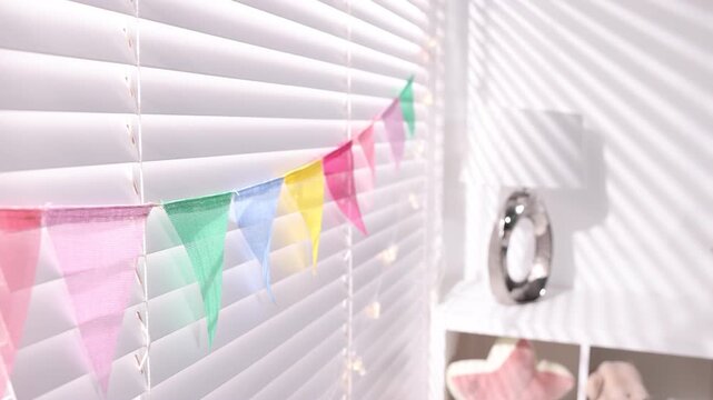 Child's room decorated with colorful flags, closeup. Camera moving forward