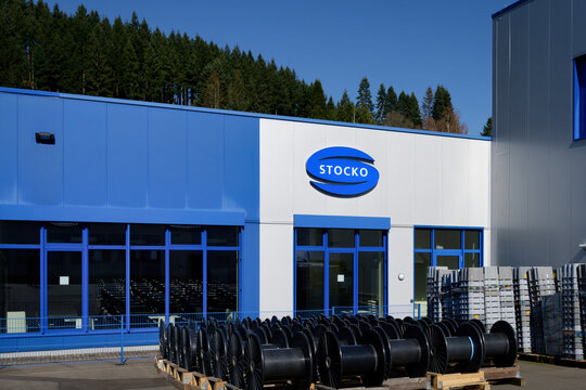 Hellenthal, Germany March 18 2026: Modern industrial facility of Stocko Contact in Hellenthal, Eifel, Germany. View with cable drums on pallets and blue sky