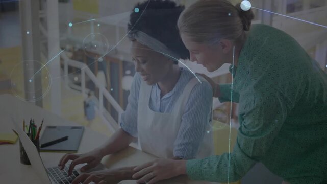 Vertical video: Mentor placing hand, guiding mentee typing on laptop in design with network overlay