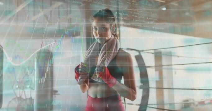 Female athlete adjusting towel near ring while finance charts rising and driving confident stance