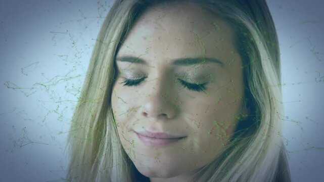 Woman closing eyes smiling opening eyes as digital overlay drifting across face, showing tech calm