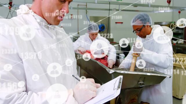 Crew tamping meat into hopper while inspector writing on clipboard as system data overlay growing