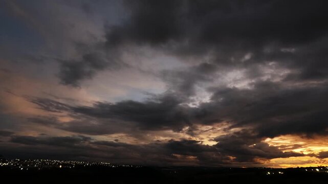 Time-lapse video capturing the movement of dense clouds from sunset into night, highlighting atmospheric dynamics and changing light conditions along the horizon.